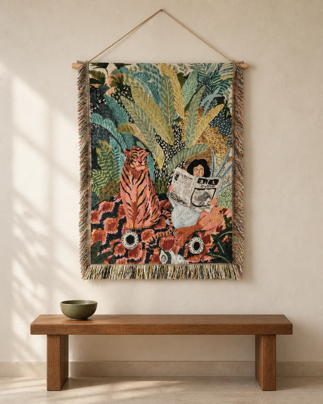 A woven jungle tapestry with an orange tiger and a person reading, above a wooden bench