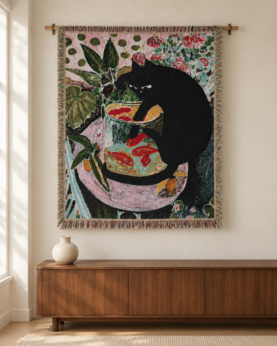 Black cat and goldfish tapestry above a rounded walnut cabinet