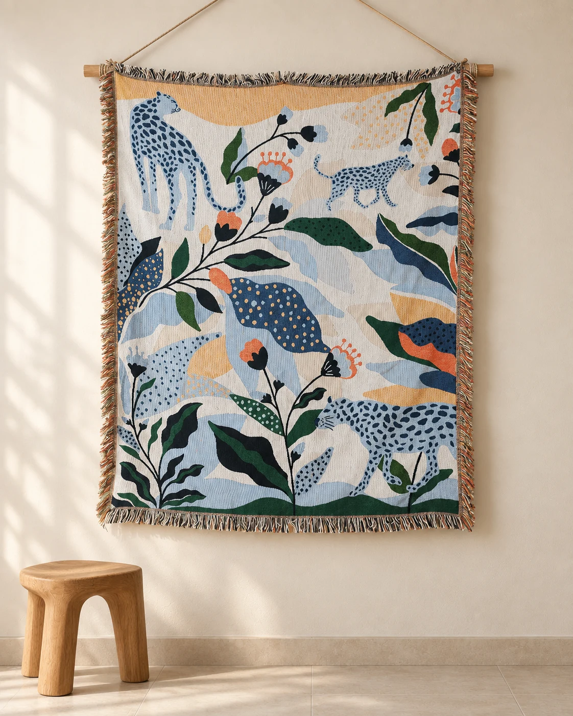 Blue spotted leopards among green leaves and orange flowers on a cream tapestry
