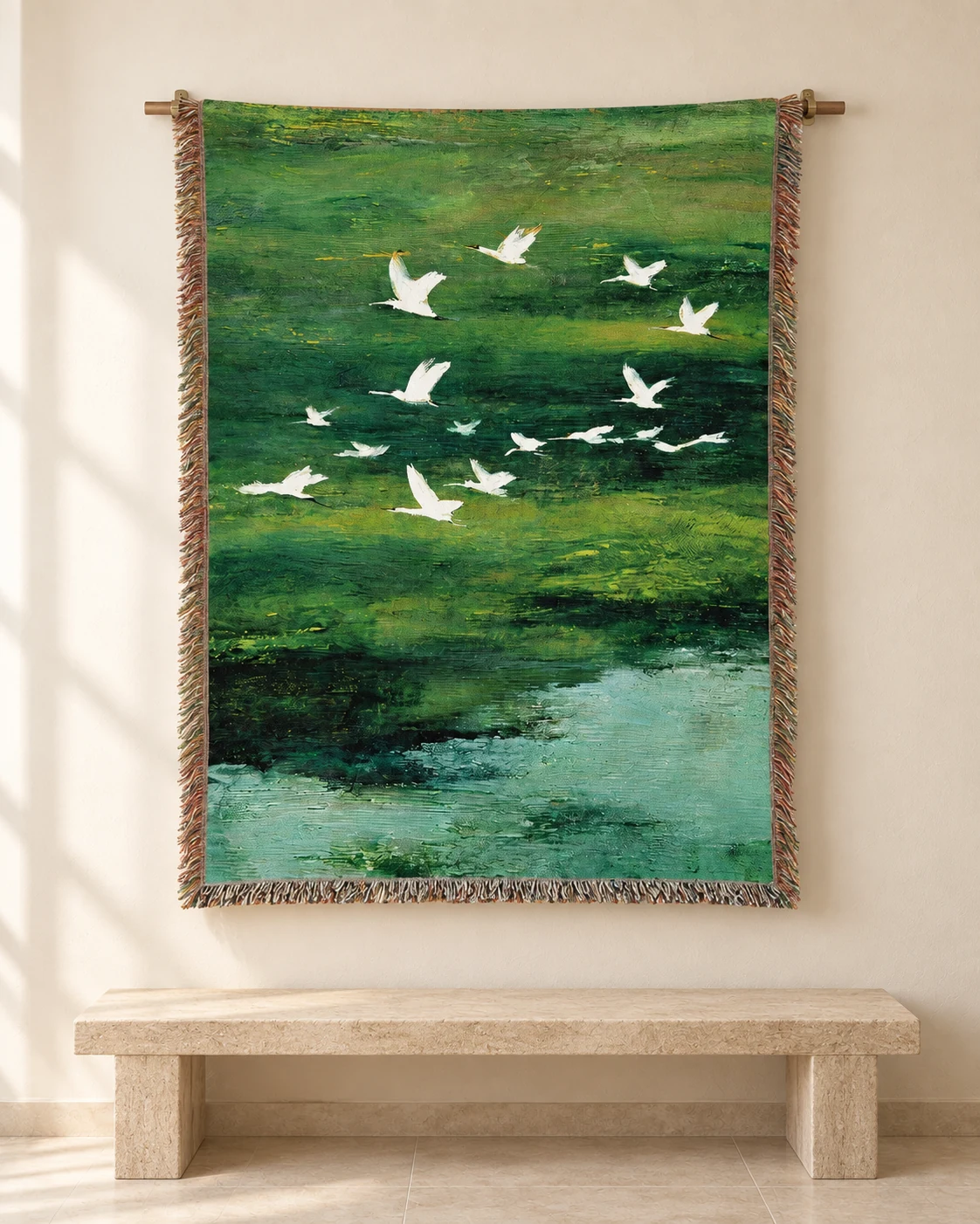 White birds flying over a painterly green landscape on a hanging tapestry