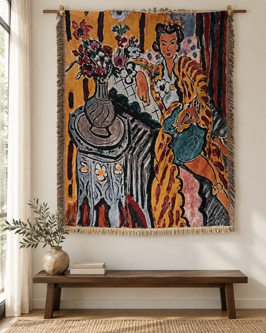 Woman seated on right in ochre patterned robe, blue-green lap, dark hair, large flower vase left on patterned table, ochre backdrop